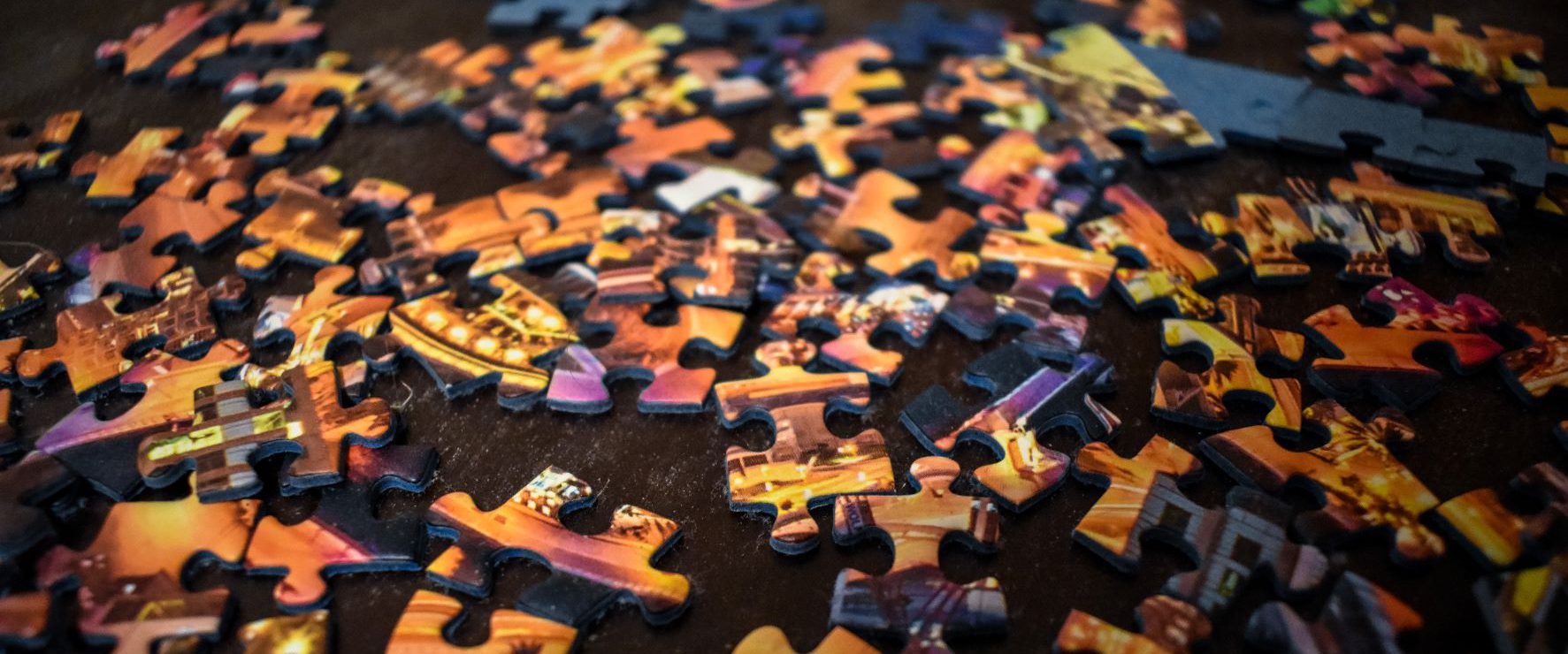 Colorful puzzle pieces laid out on a table.